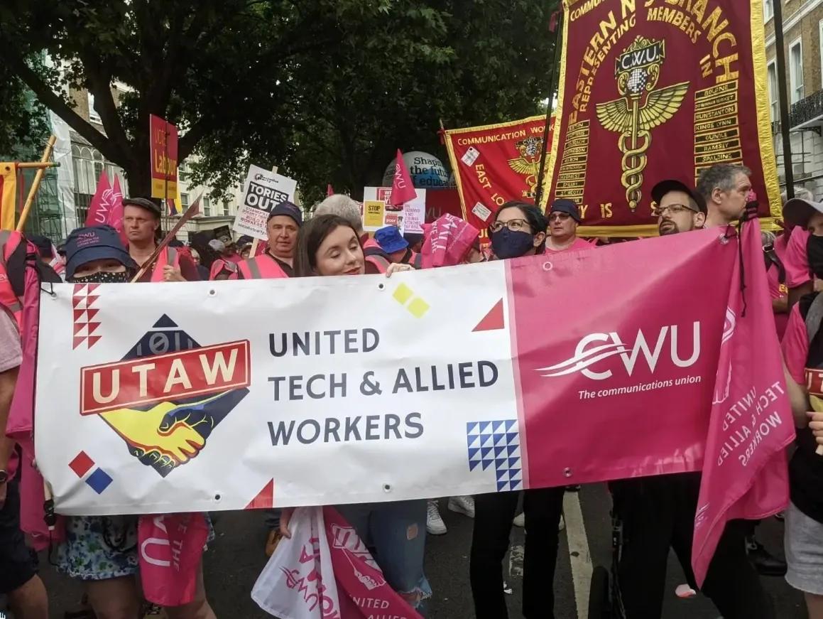 UTAW banner at a march people holding sign