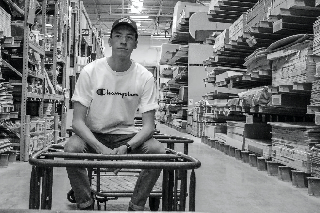 A worker sitting in a warehouse